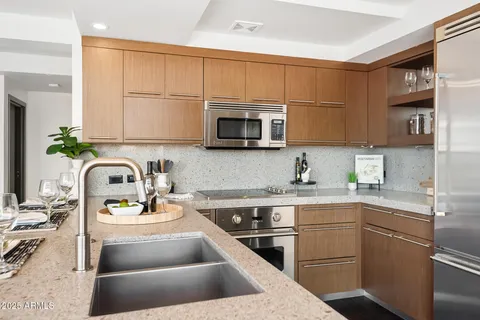 a kitchen with stainless steel appliances sink a microwave and cabinets