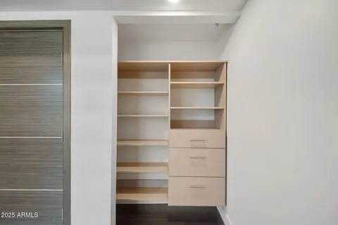 a view of walk in closet with empty racks