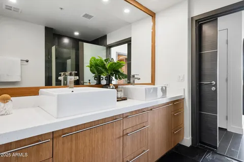 a bathroom with a glass shower door and a mirror