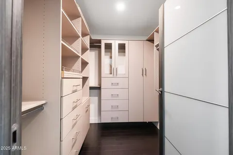 a bedroom with a bed a large window and flat screen tv