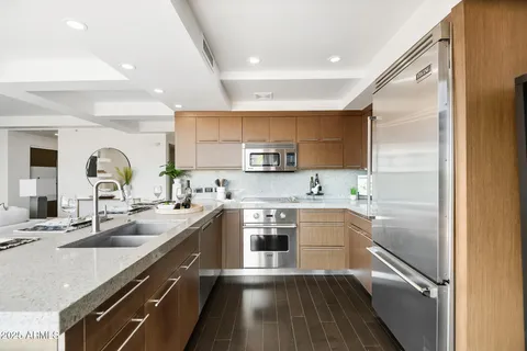 a kitchen with stainless steel appliances granite countertop a sink and cabinets