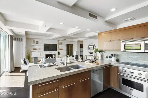 a kitchen with a sink stainless steel appliances and white cabinets