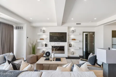 a living room with fireplace furniture and a flat screen tv