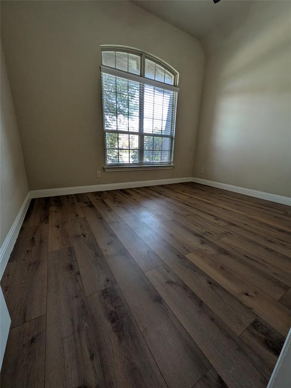 820 Callcott Street McKinney, TX 75072 - Photo 18 of 22 a view of an empty room with wooden floor and a window
