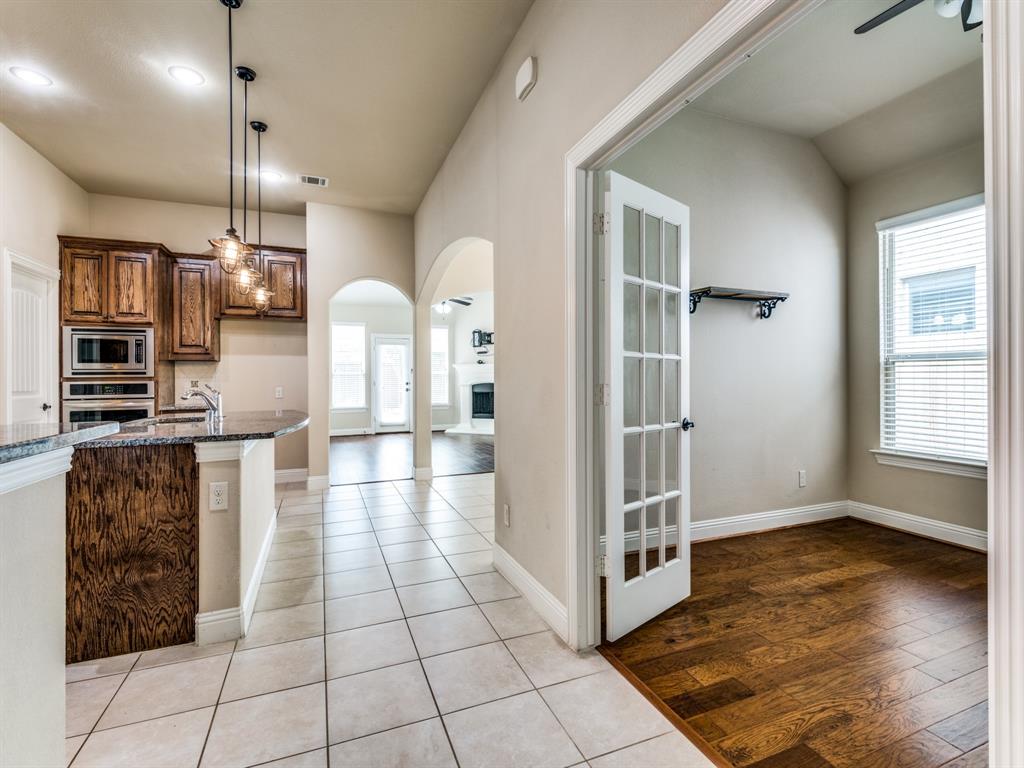 820 Callcott Street McKinney, TX 75072 - Photo 4 of 22 a view of a kitchen with a sink and dishwasher wooden floor and cabinets
