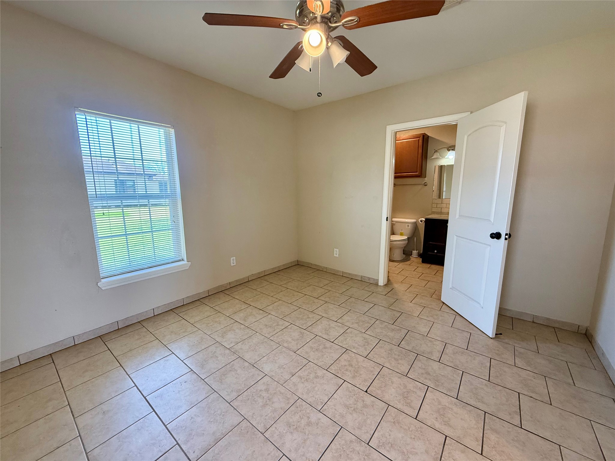 429 West 2nd Street Freeport, TX 77541 - Photo 13 of 49 a view of an empty room with window and chandelier fan