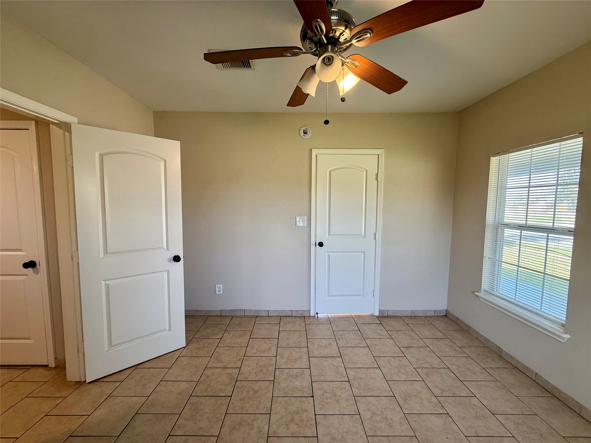 429 West 2nd Street Freeport, TX 77541 - Photo 18 of 49 a view of an empty room with window and chandelier fan
