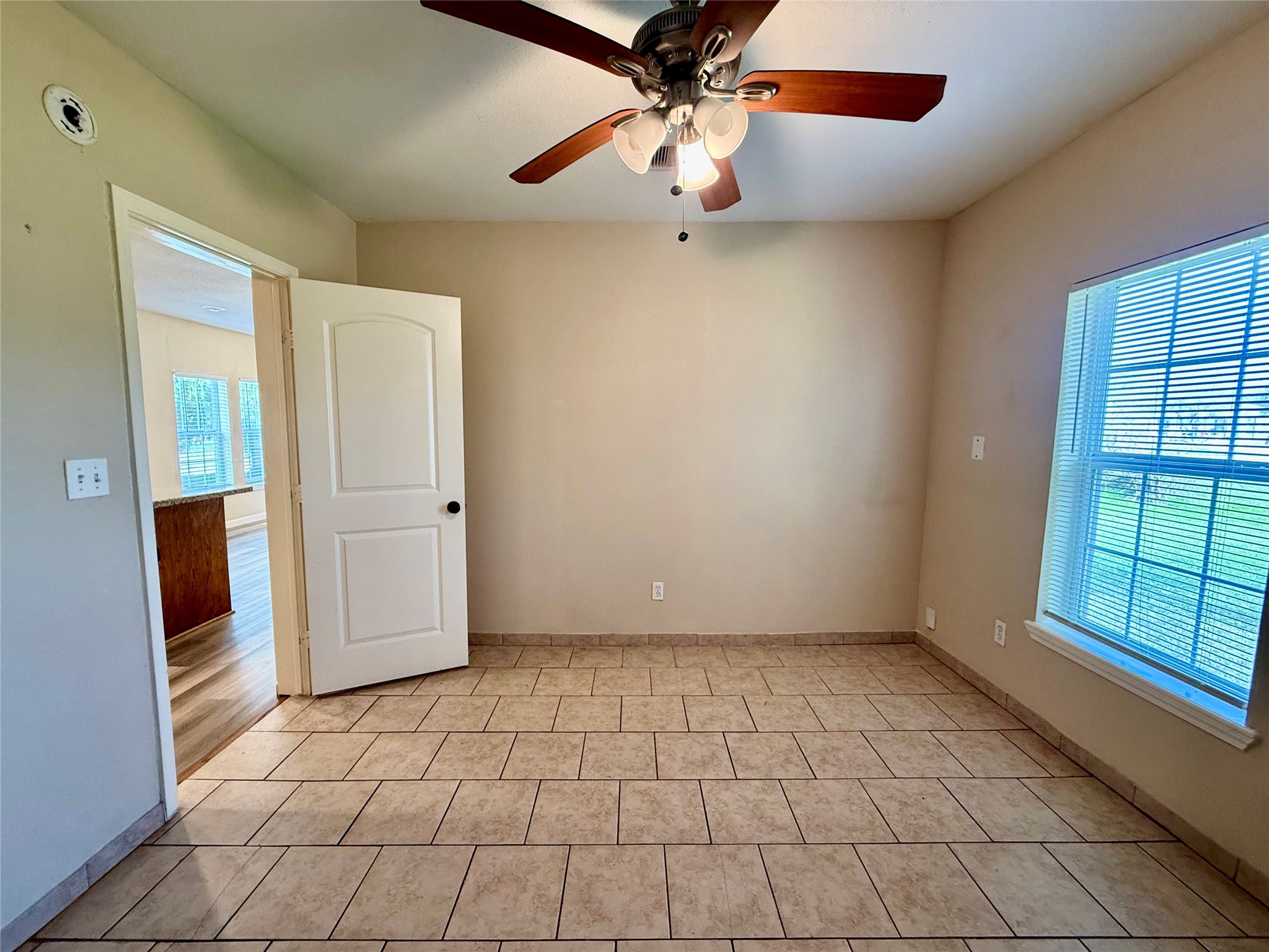 429 West 2nd Street Freeport, TX 77541 - Photo 22 of 49 an empty room with windows and fan