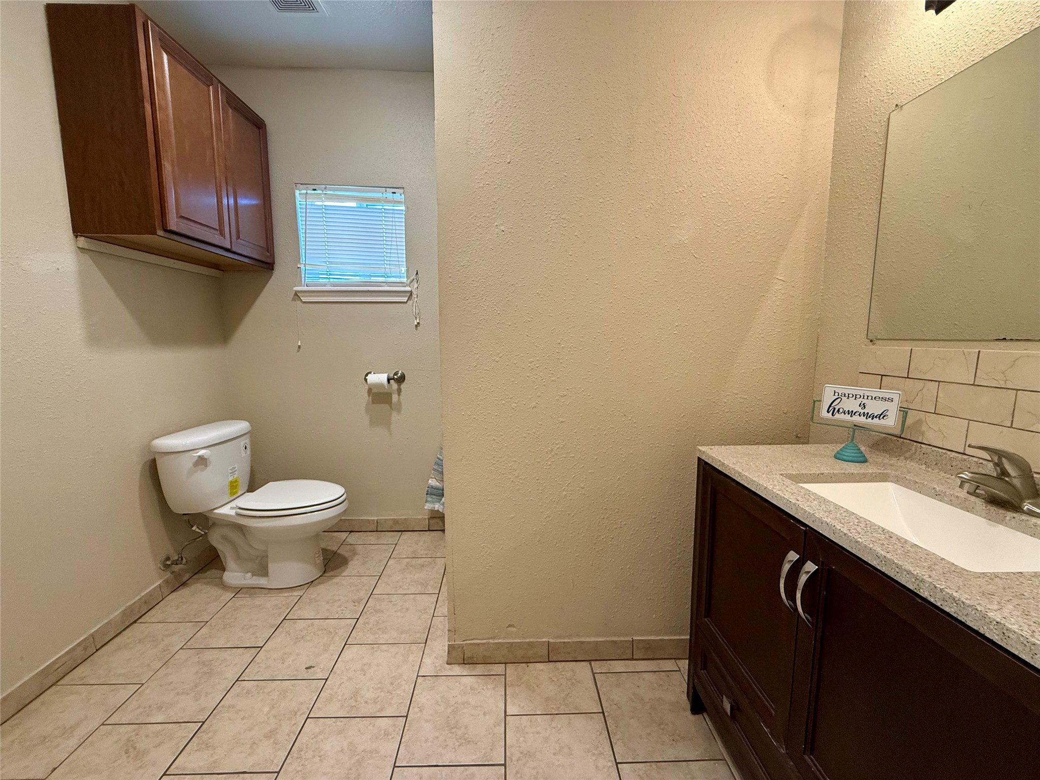 429 West 2nd Street Freeport, TX 77541 - Photo 23 of 49 a bathroom with a granite countertop toilet and a sink