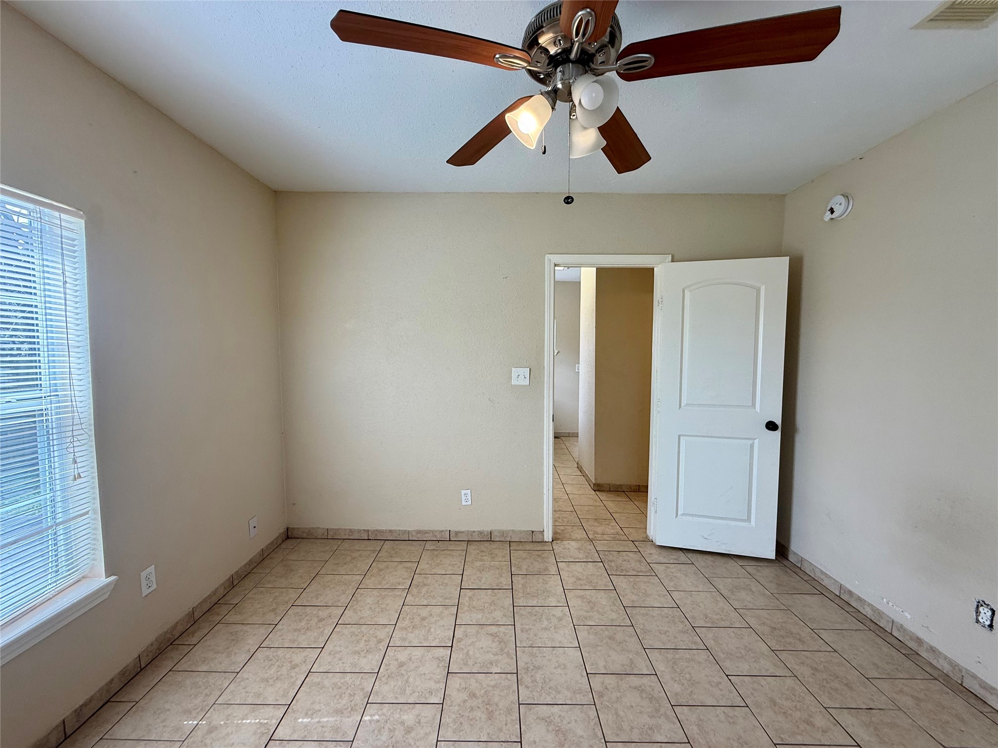 429 West 2nd Street Freeport, TX 77541 - Photo 27 of 49 an empty room with windows and fan
