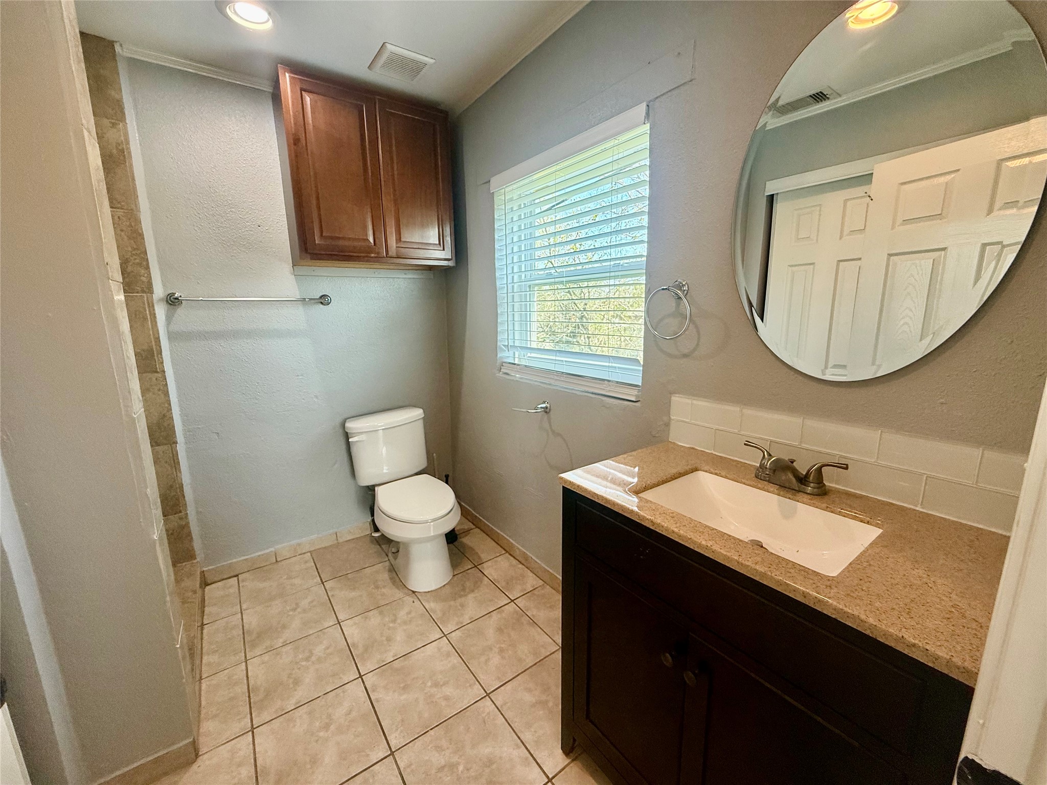 429 West 2nd Street Freeport, TX 77541 - Photo 37 of 49 a bathroom with a sink a toilet and mirror