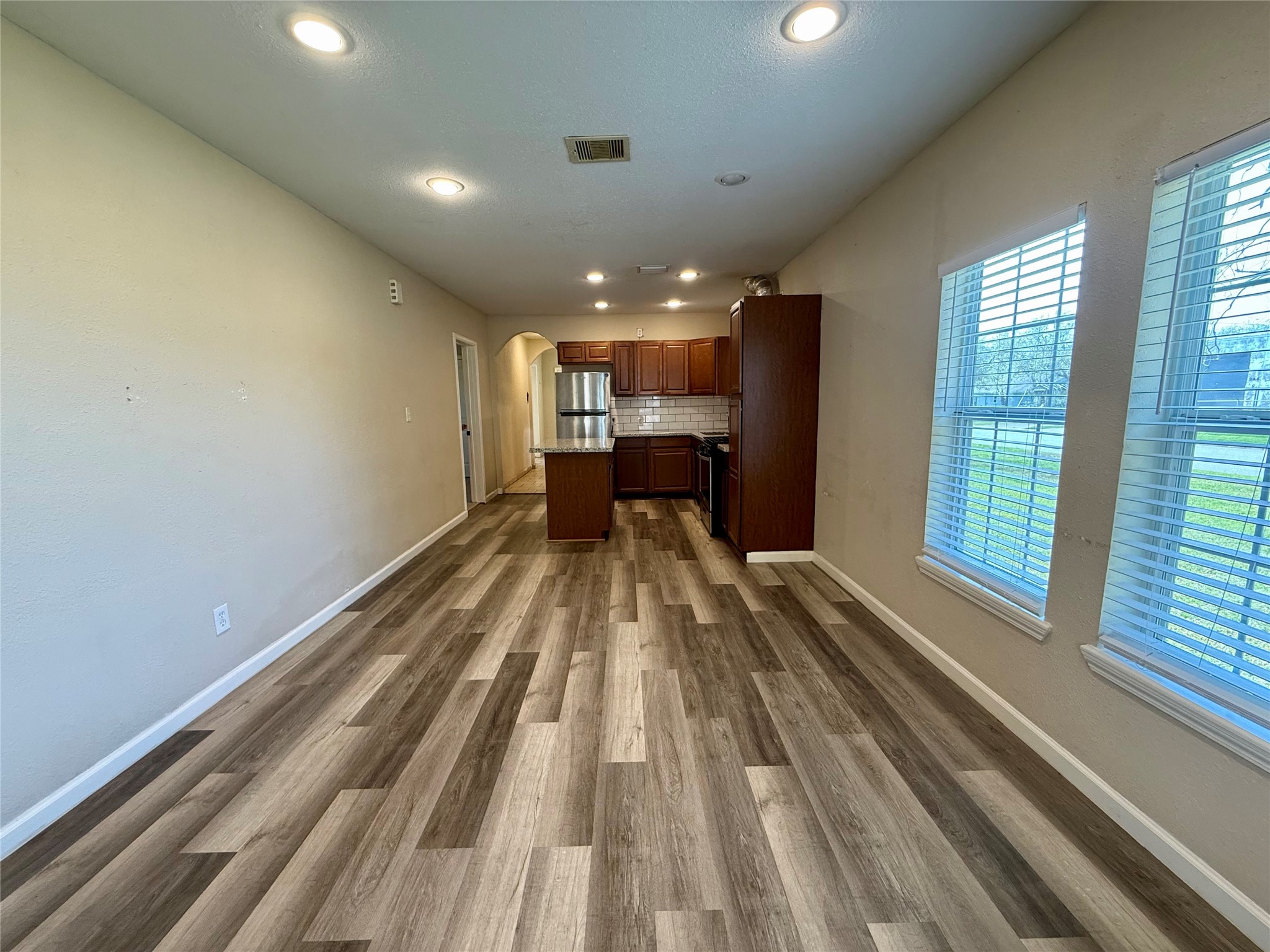 429 West 2nd Street Freeport, TX 77541 - Photo 5 of 49 a view of a room with wooden floor kitchen view and a window