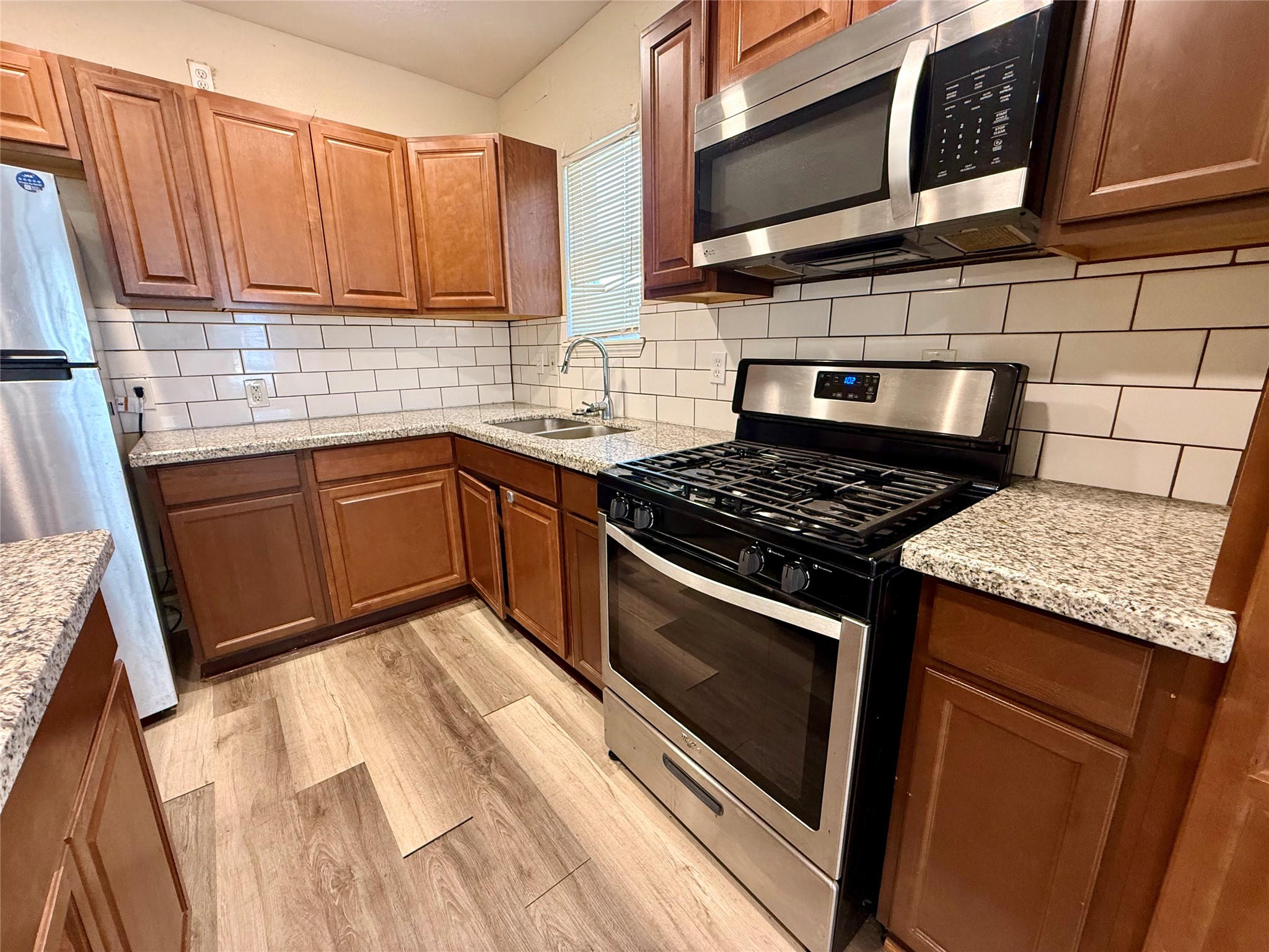 429 West 2nd Street Freeport, TX 77541 - Photo 6 of 49 a kitchen with stainless steel appliances granite countertop a stove a sink and a microwave