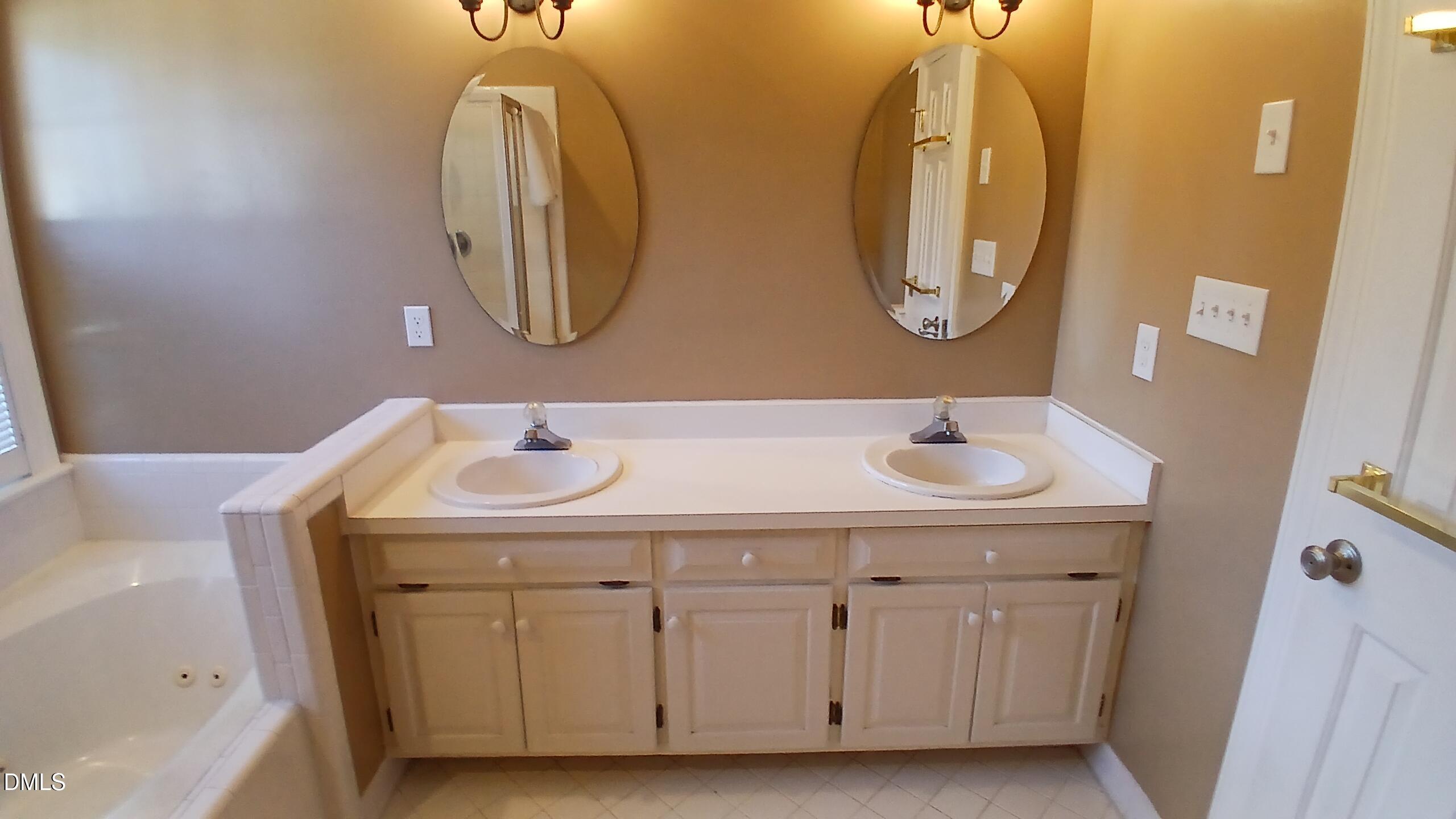 1817 Thorpshire Drive Raleigh, NC 27615 - Photo 21 of 36 a bathroom with a sink and a mirror