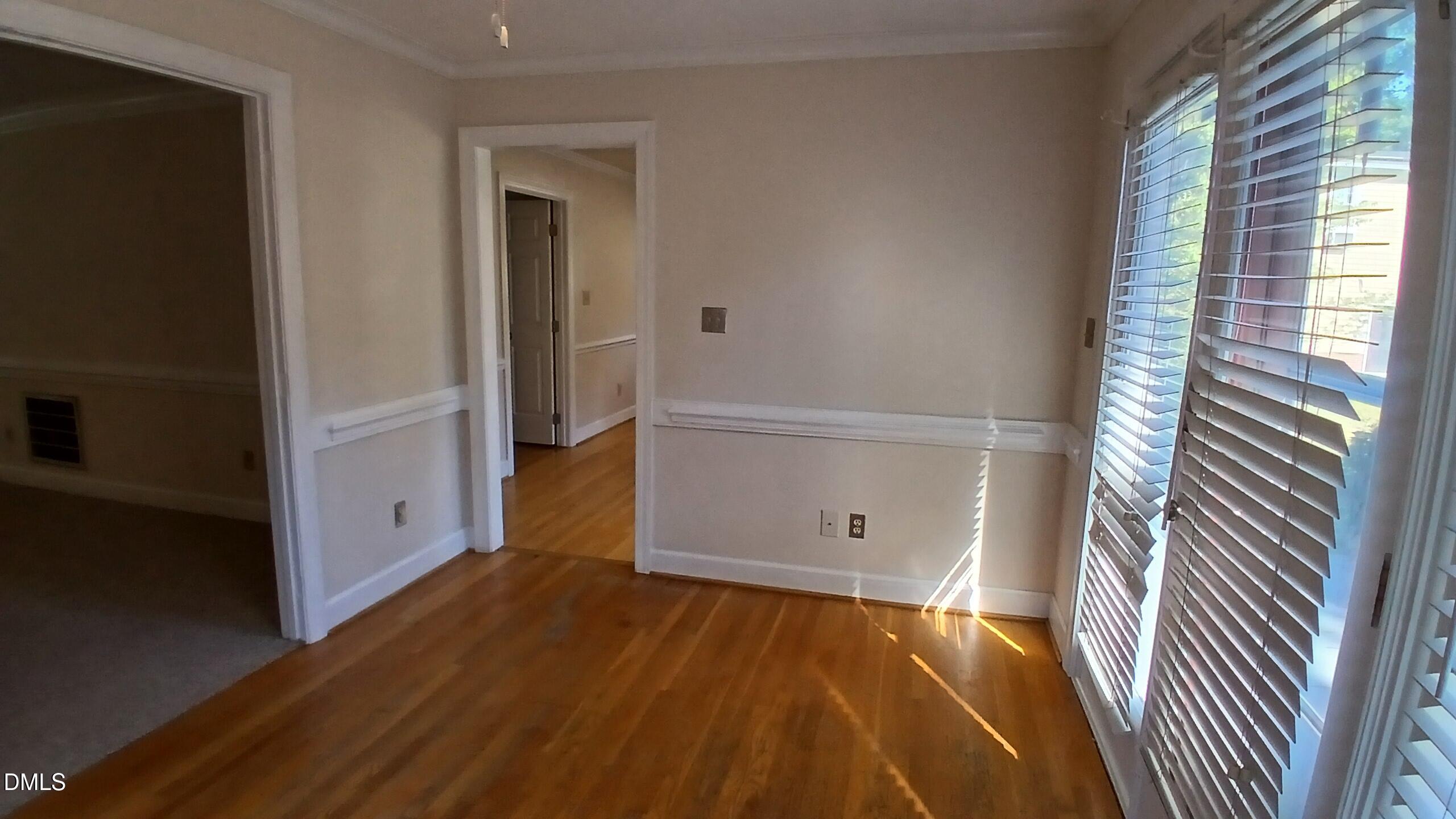 1817 Thorpshire Drive Raleigh, NC 27615 - Photo 10 of 36 wooden floor and window in an empty room