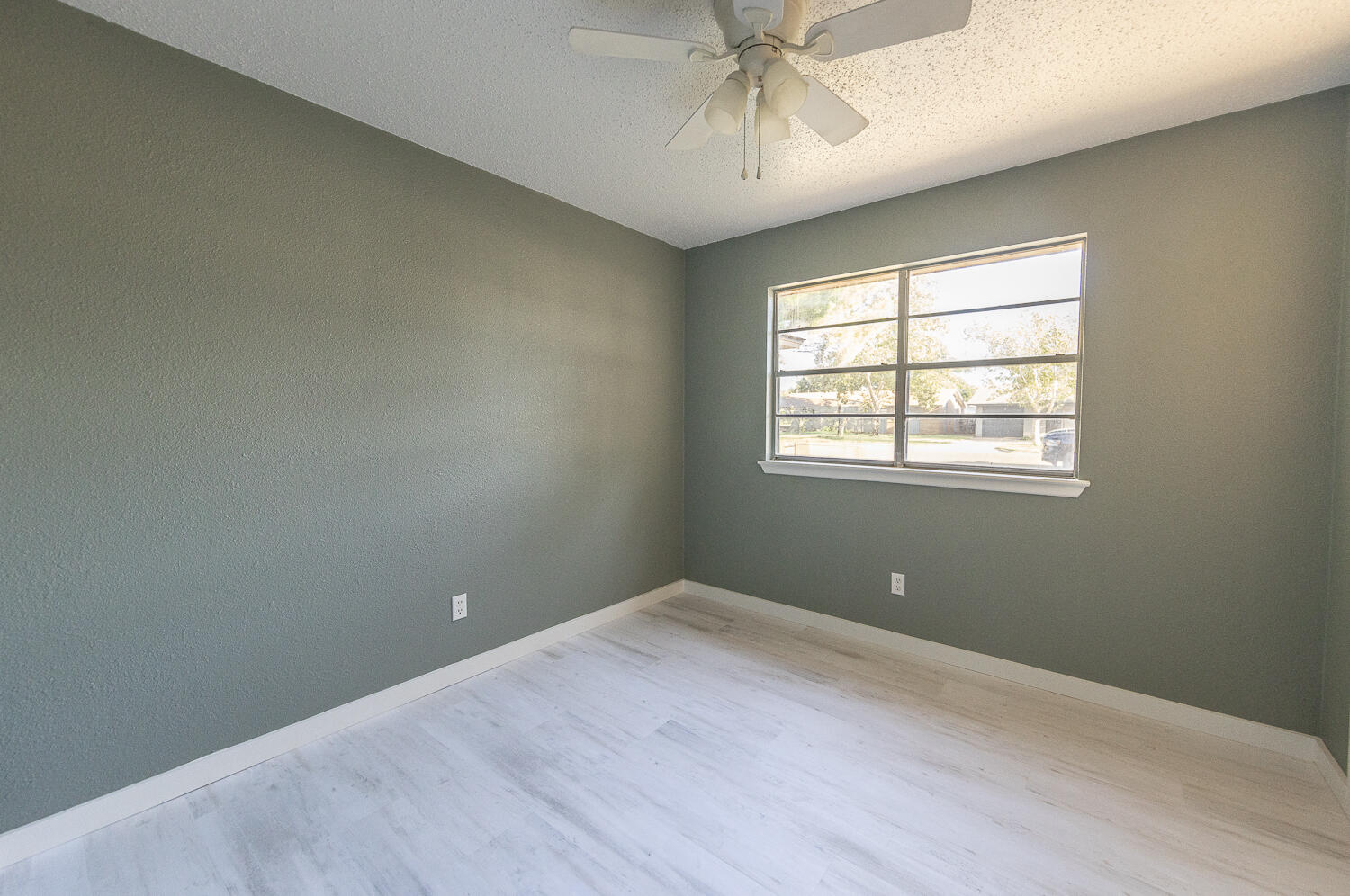 5405 49th Street Lubbock, TX 79414 - Photo 13 of 25 an empty room with a window and ceiling fan