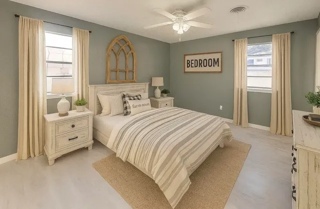 a spacious bedroom with a large bed and a chandelier