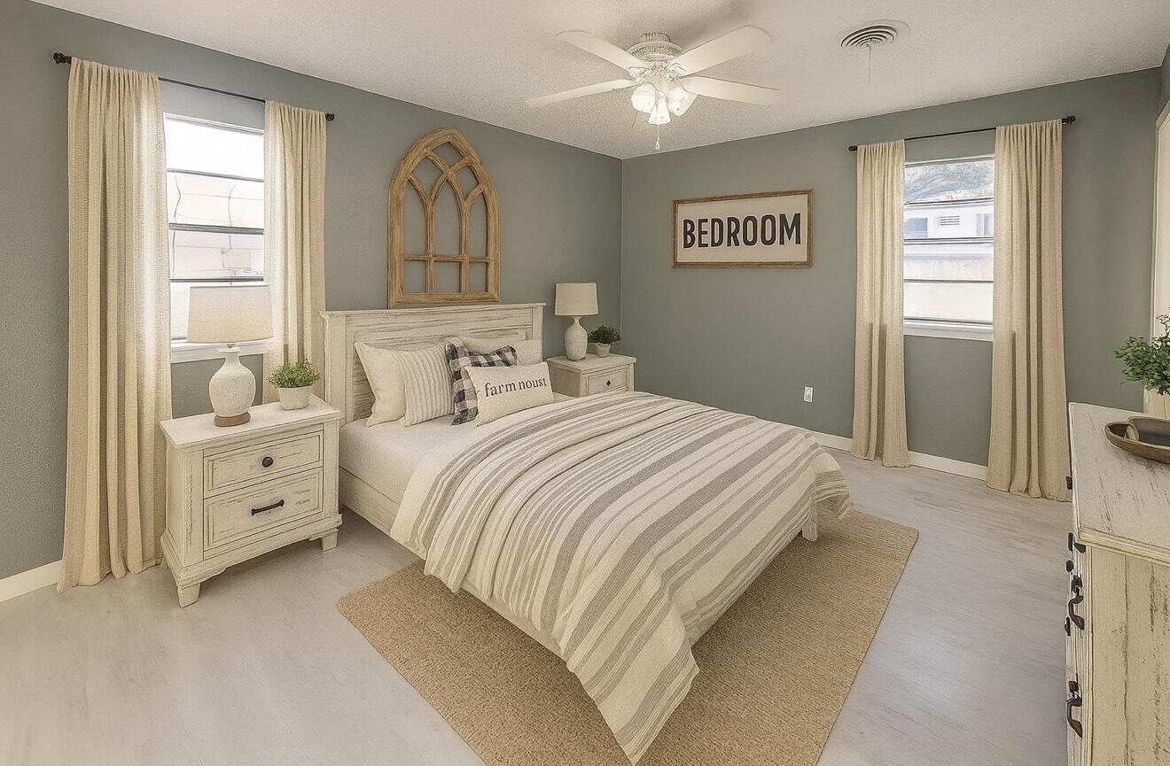 5405 49th Street Lubbock, TX 79414 - Photo 17 of 25 a spacious bedroom with a large bed and a chandelier