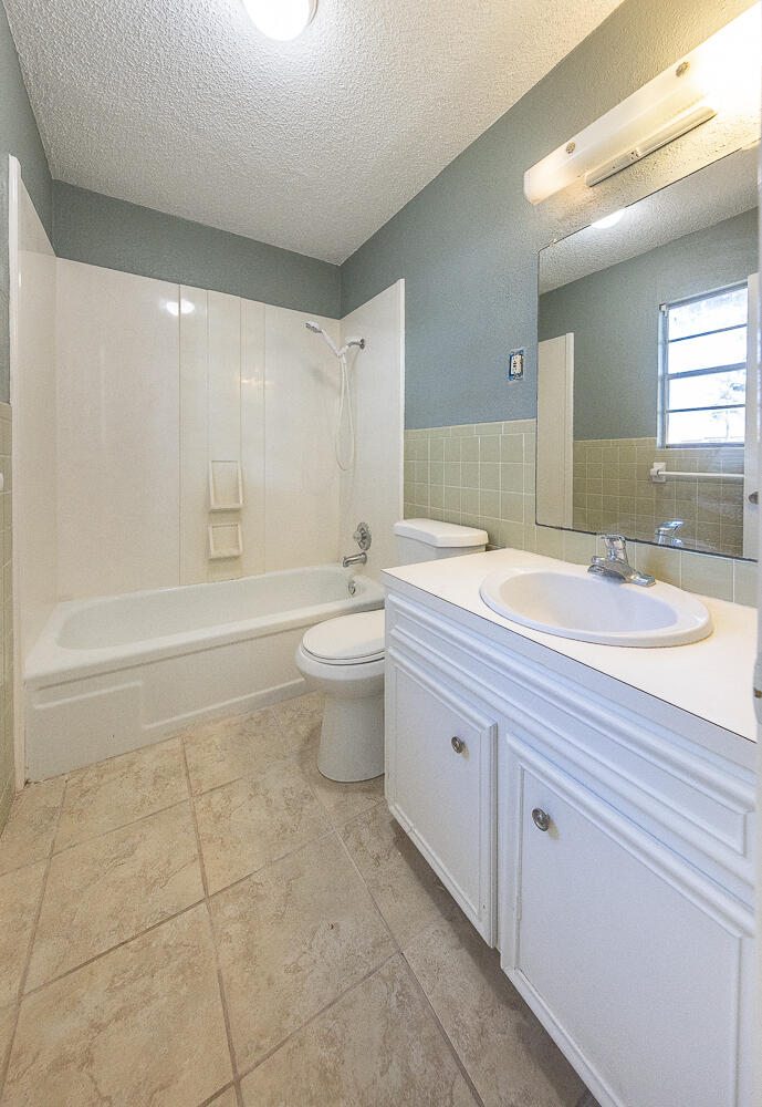 5405 49th Street Lubbock, TX 79414 - Photo 21 of 25 a bathroom with a double vanity sink a toilet and a bathtub