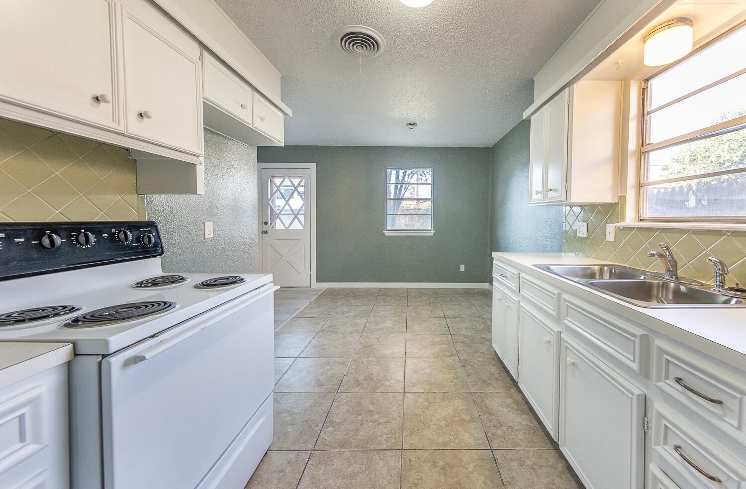 5405 49th Street Lubbock, TX 79414 - Photo 3 of 25 a kitchen that has a sink and a stove