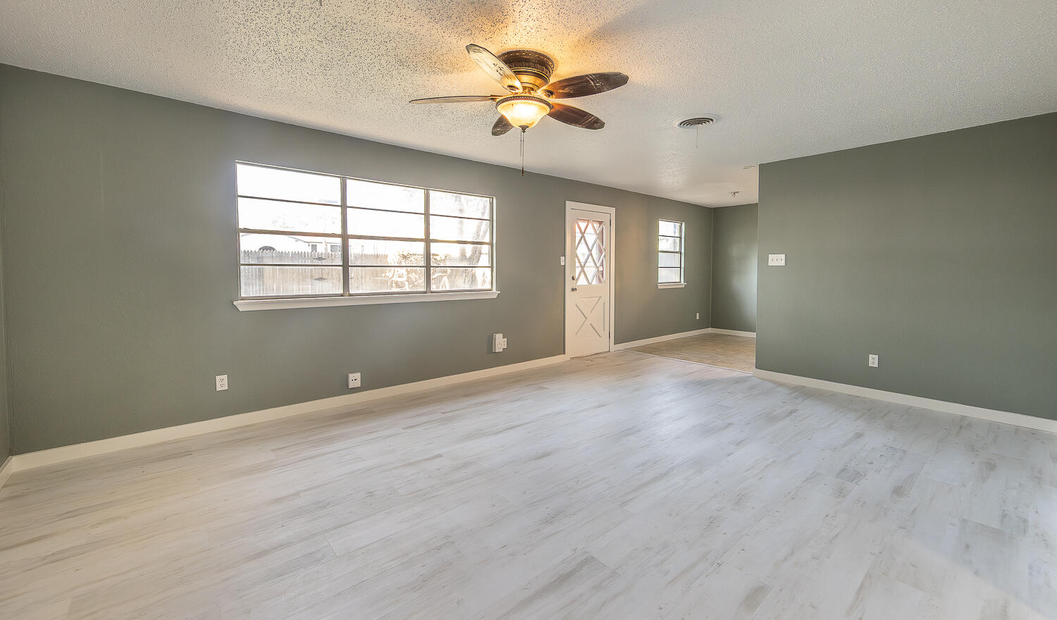 5405 49th Street Lubbock, TX 79414 - Photo 4 of 25 wooden floor in an empty room with a window