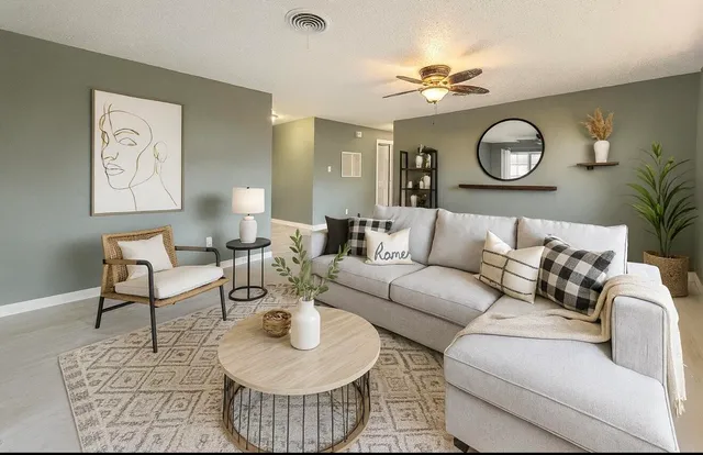 a living room with furniture a clock and a chandelier