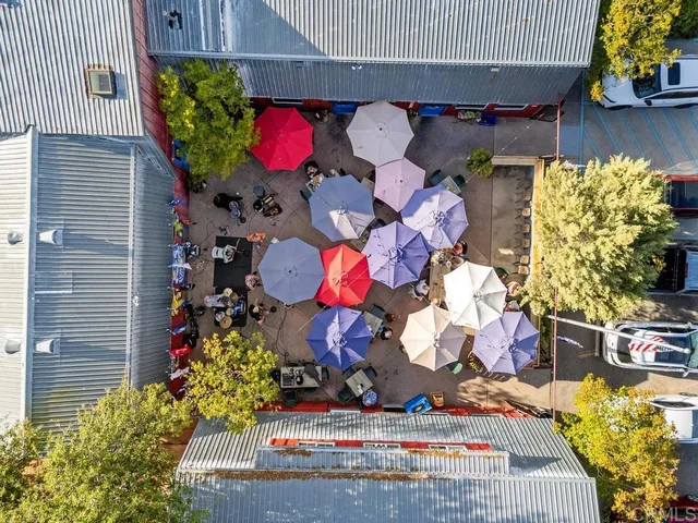 a outdoor dining area with lots of tables and chairs