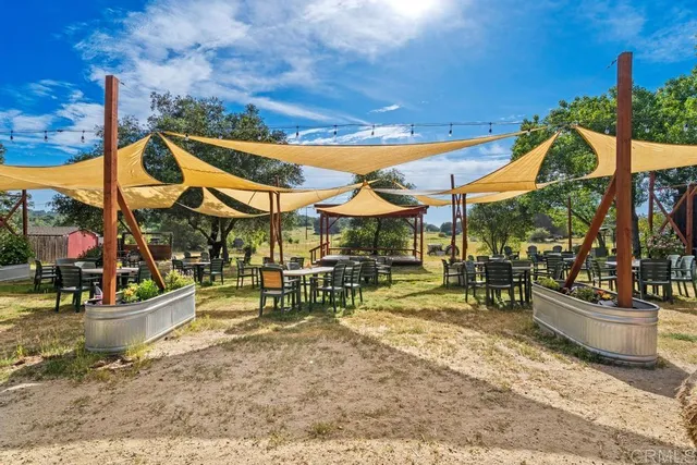 a backyard of a house with table and chairs
