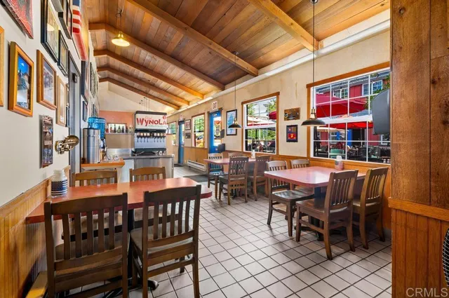 a dining room with furniture and wooden floor
