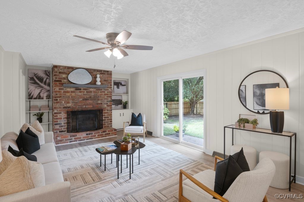 11511 Rochelle Road Chester, VA 23831 - Photo 23 of 32 a living room with furniture a fireplace and a large window