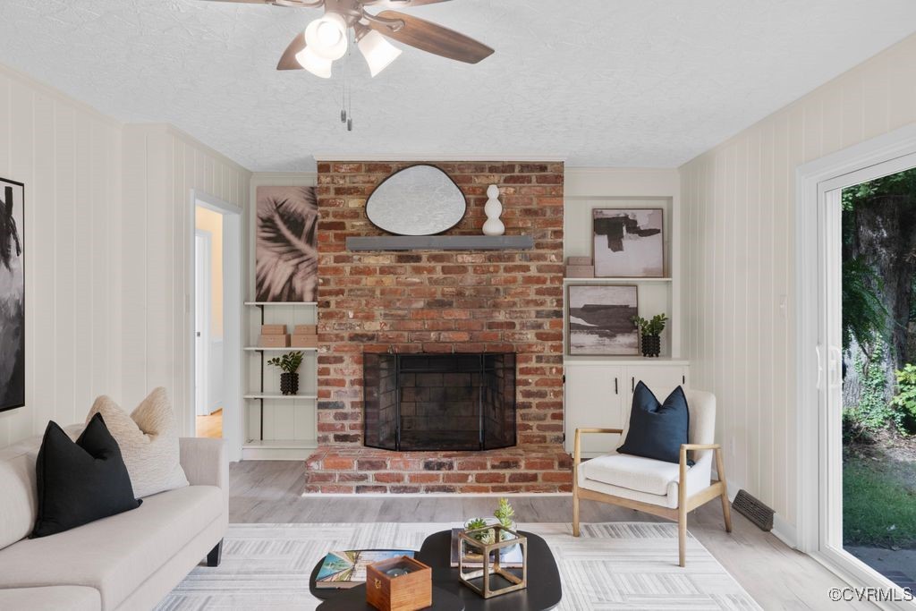 11511 Rochelle Road Chester, VA 23831 - Photo 24 of 32 a living room with furniture a fireplace and a potted plant