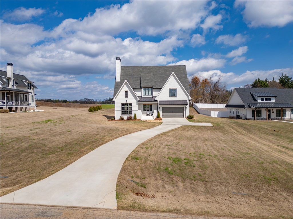 677 Lightwood Road Hartwell, GA 30643 - Photo 2 of 42 This charming modern farmhouse offers a welcoming facade with a paved driveway and ample yard space.