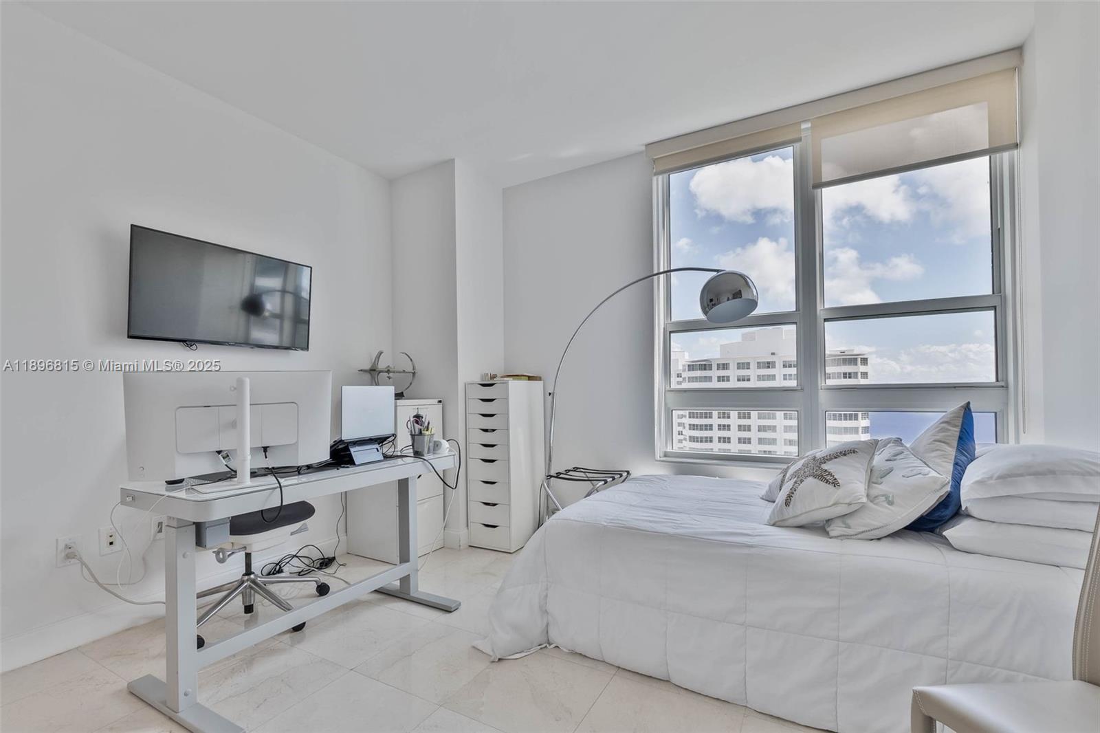 951 Brickell Avenue, Unit 1606 Miami, FL 33131 - Photo 11 of 30 a bedroom with a bed and a flat screen tv