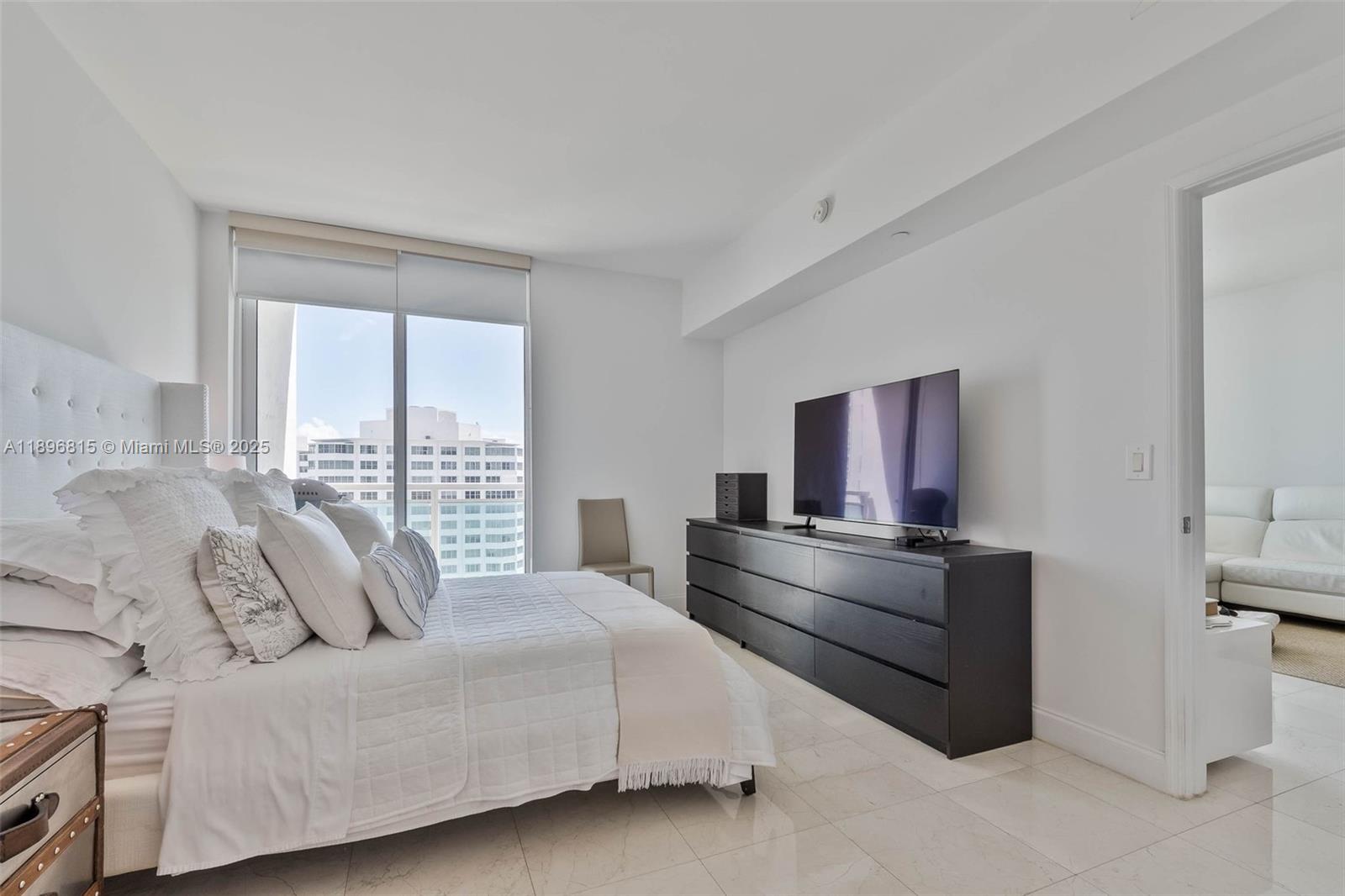 951 Brickell Avenue, Unit 1606 Miami, FL 33131 - Photo 13 of 30 a living room with furniture and a large window