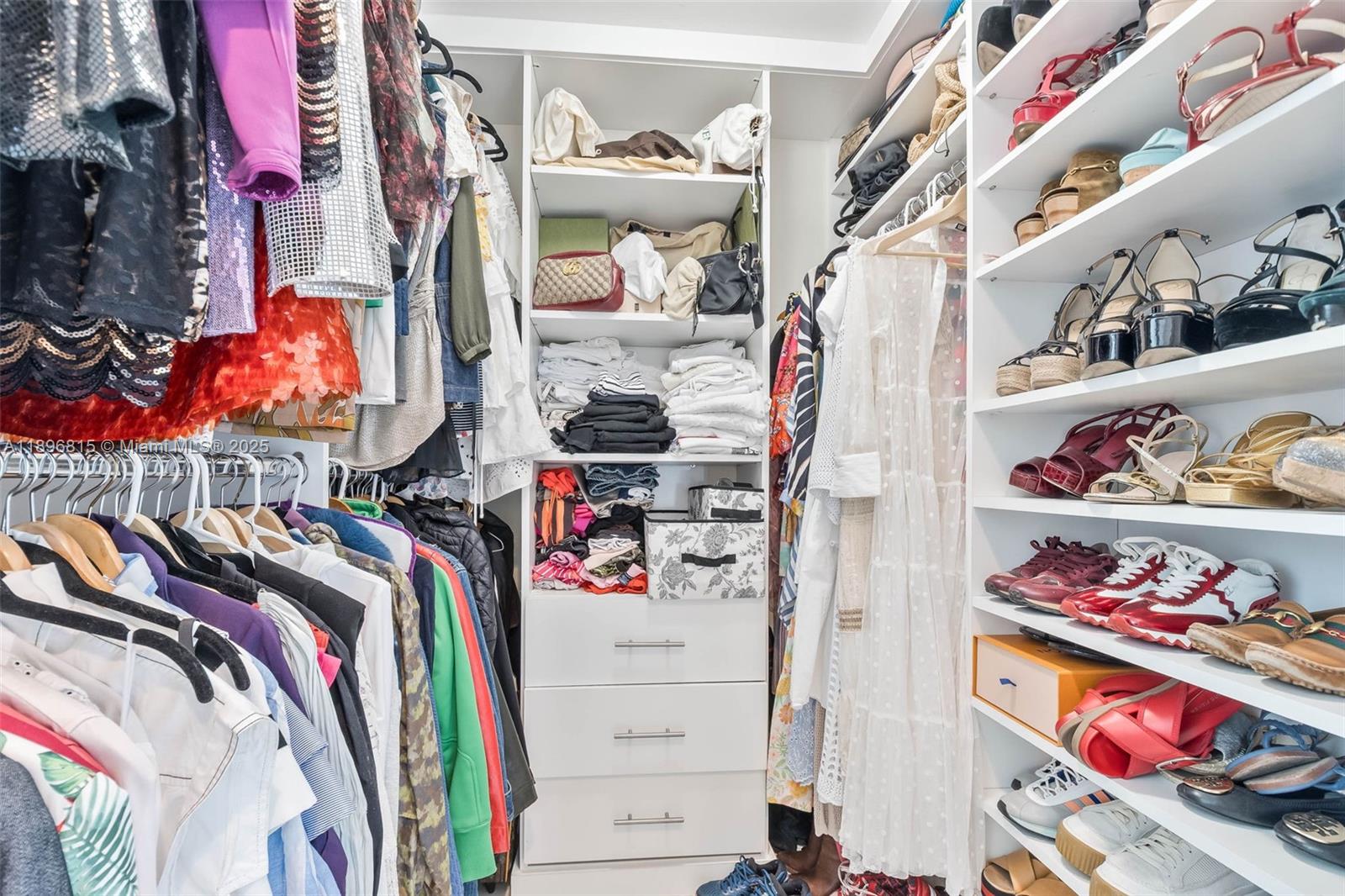 951 Brickell Avenue, Unit 1606 Miami, FL 33131 - Photo 14 of 30 a view of walk in closet with clothes and shoes