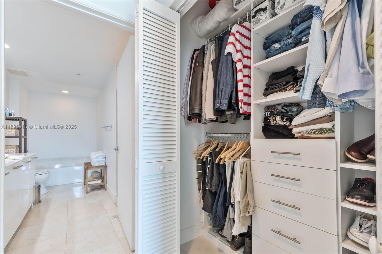 951 Brickell Avenue, Unit 1606 Miami, FL 33131 - Photo 15 of 30 a view of walk in closet with clothes and shoes