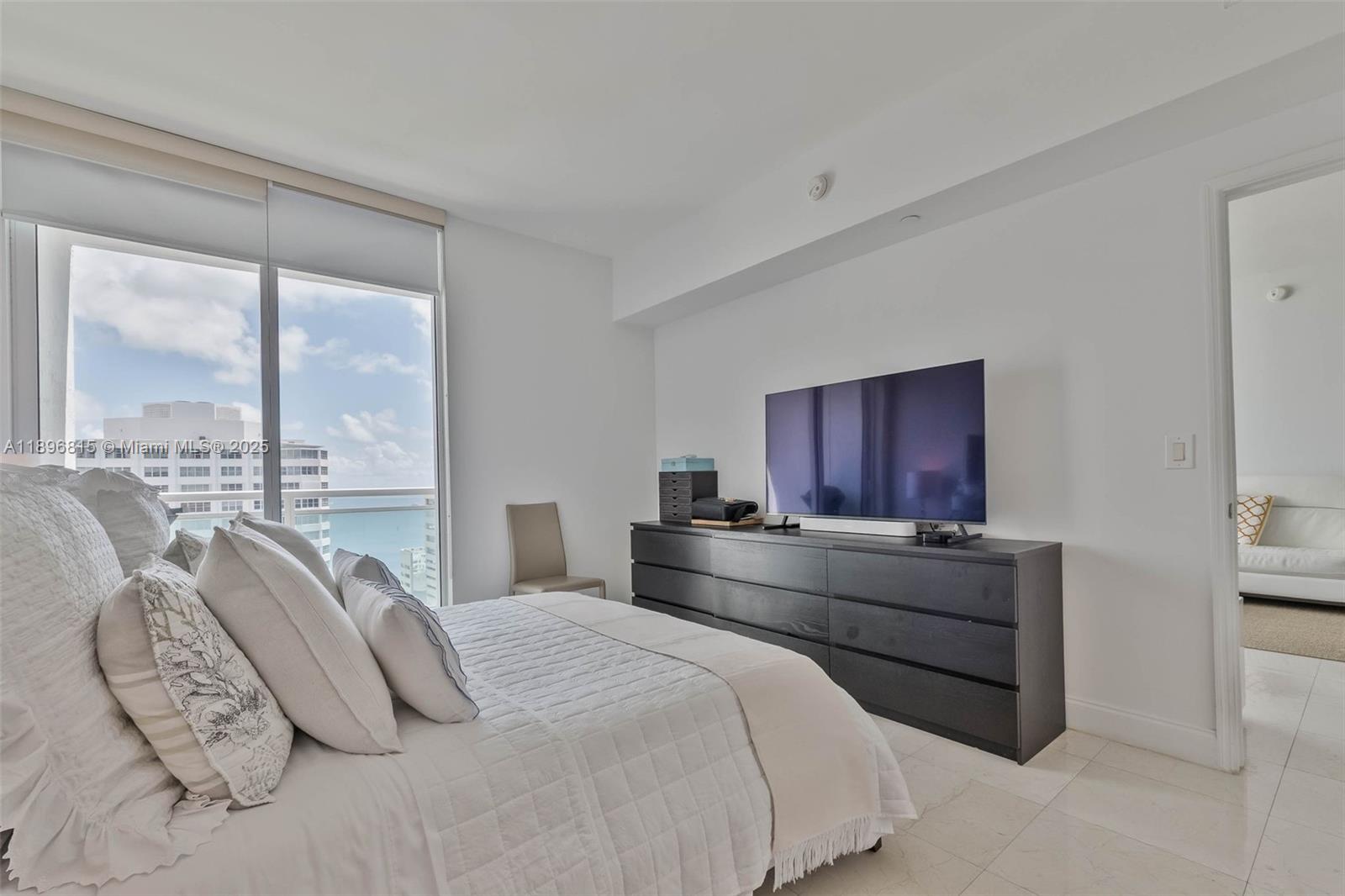 951 Brickell Avenue, Unit 1606 Miami, FL 33131 - Photo 20 of 30 a bedroom with a large bed and a large window
