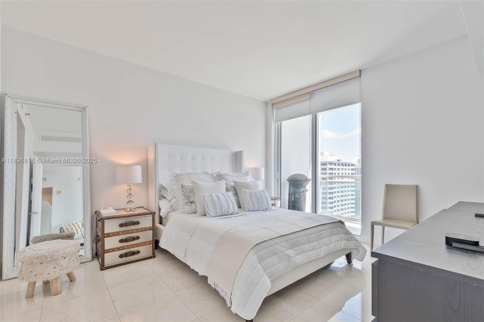 951 Brickell Avenue, Unit 1606 Miami, FL 33131 - Photo 30 of 30 a bedroom with a bed and a window