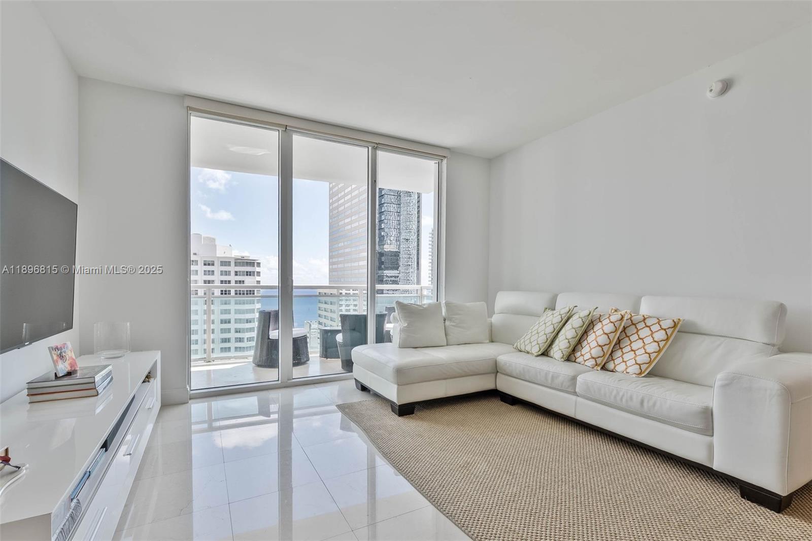 951 Brickell Avenue, Unit 1606 Miami, FL 33131 - Photo 6 of 30 a living room with furniture and a large window