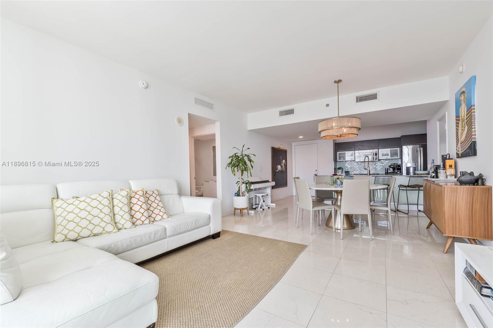 951 Brickell Avenue, Unit 1606 Miami, FL 33131 - Photo 8 of 30 a living room with furniture and a large window