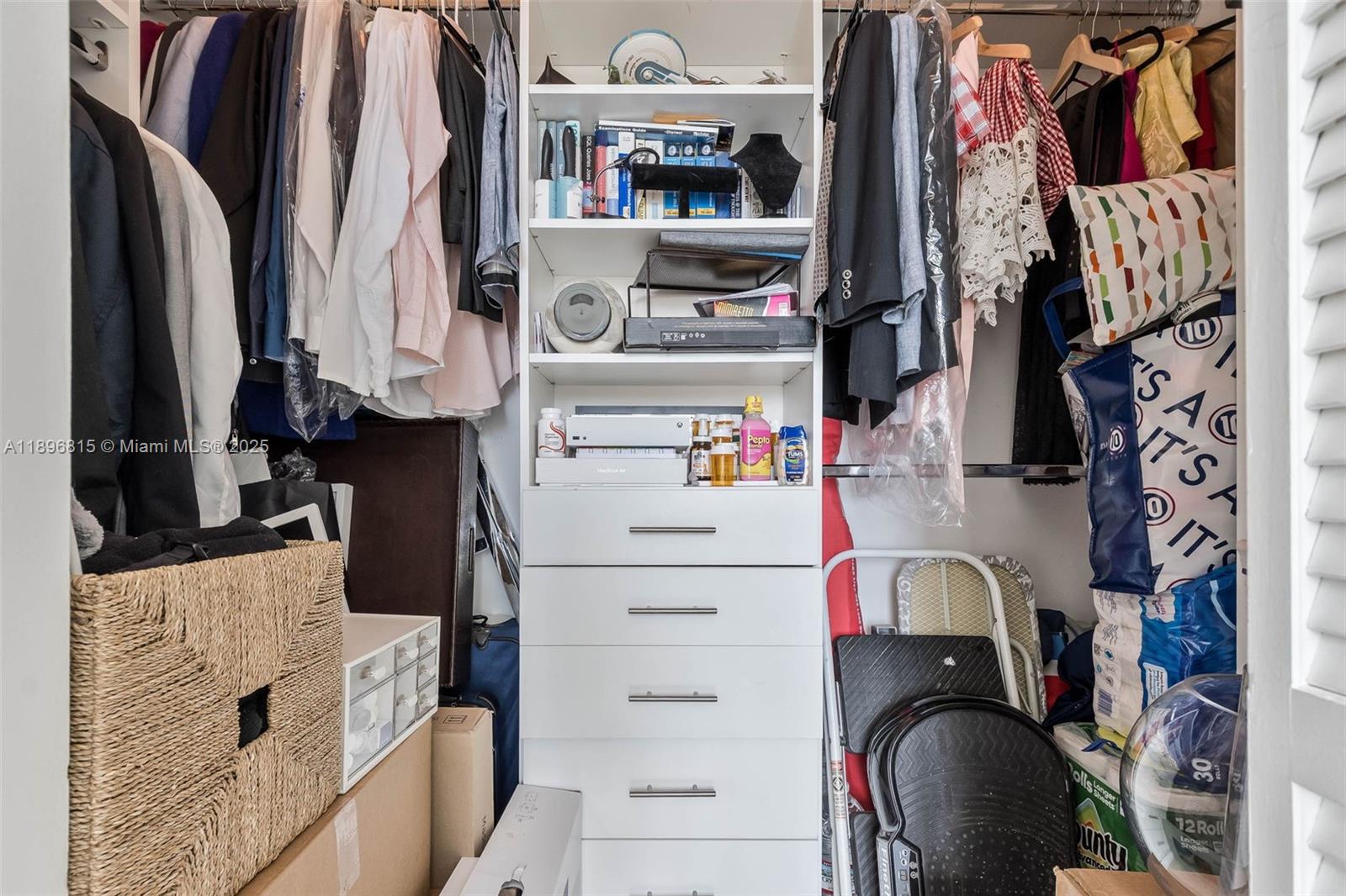 951 Brickell Avenue, Unit 1606 Miami, FL 33131 - Photo 9 of 30 a view of walk in closet with clothes and shoes