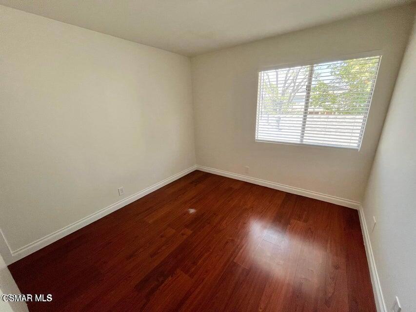 540 Spring Road, Unit 94 Moorpark, CA 93021 - Photo 16 of 22 an empty room with wooden floor and windows
