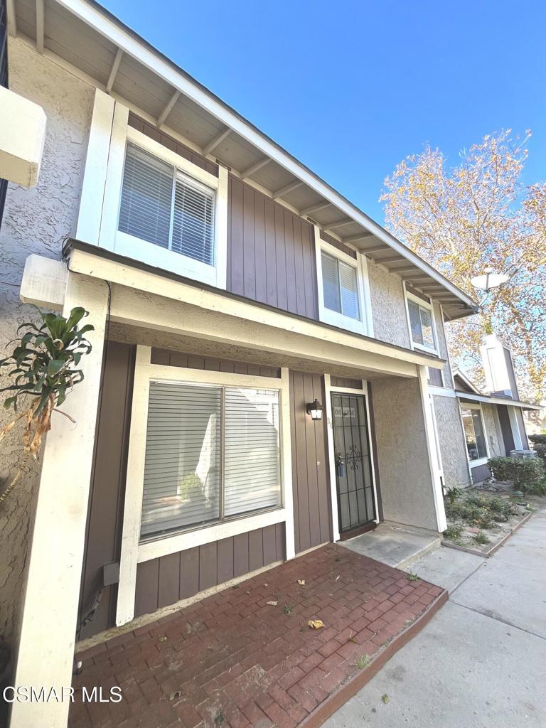 540 Spring Road, Unit 94 Moorpark, CA 93021 - Photo 2 of 22 a front view of a house with a yard