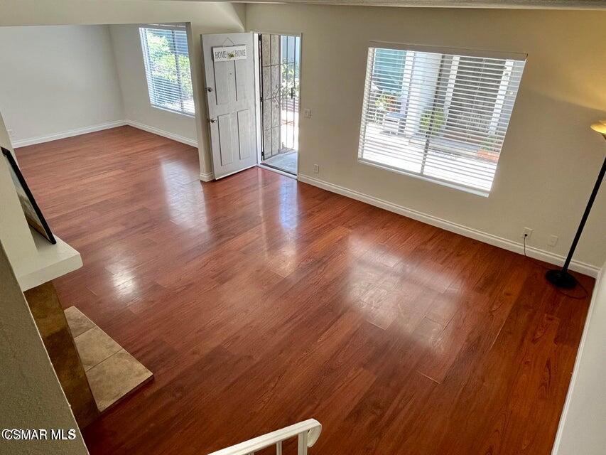 540 Spring Road, Unit 94 Moorpark, CA 93021 - Photo 4 of 22 a view of an empty room with wooden floor and a window