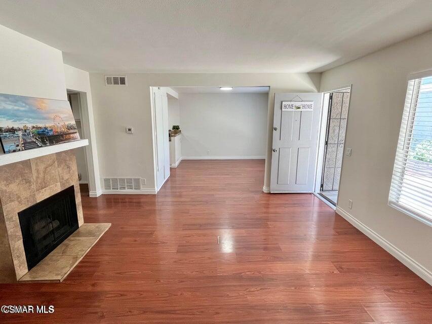 540 Spring Road, Unit 94 Moorpark, CA 93021 - Photo 5 of 22 a view of a livingroom with wooden floor and a fireplace