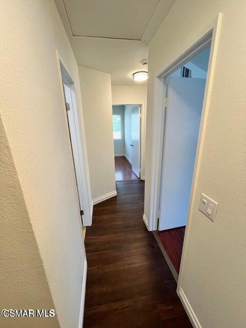 540 Spring Road, Unit 94 Moorpark, CA 93021 - Photo 9 of 22 a view of a hallway with wooden floor and staircase