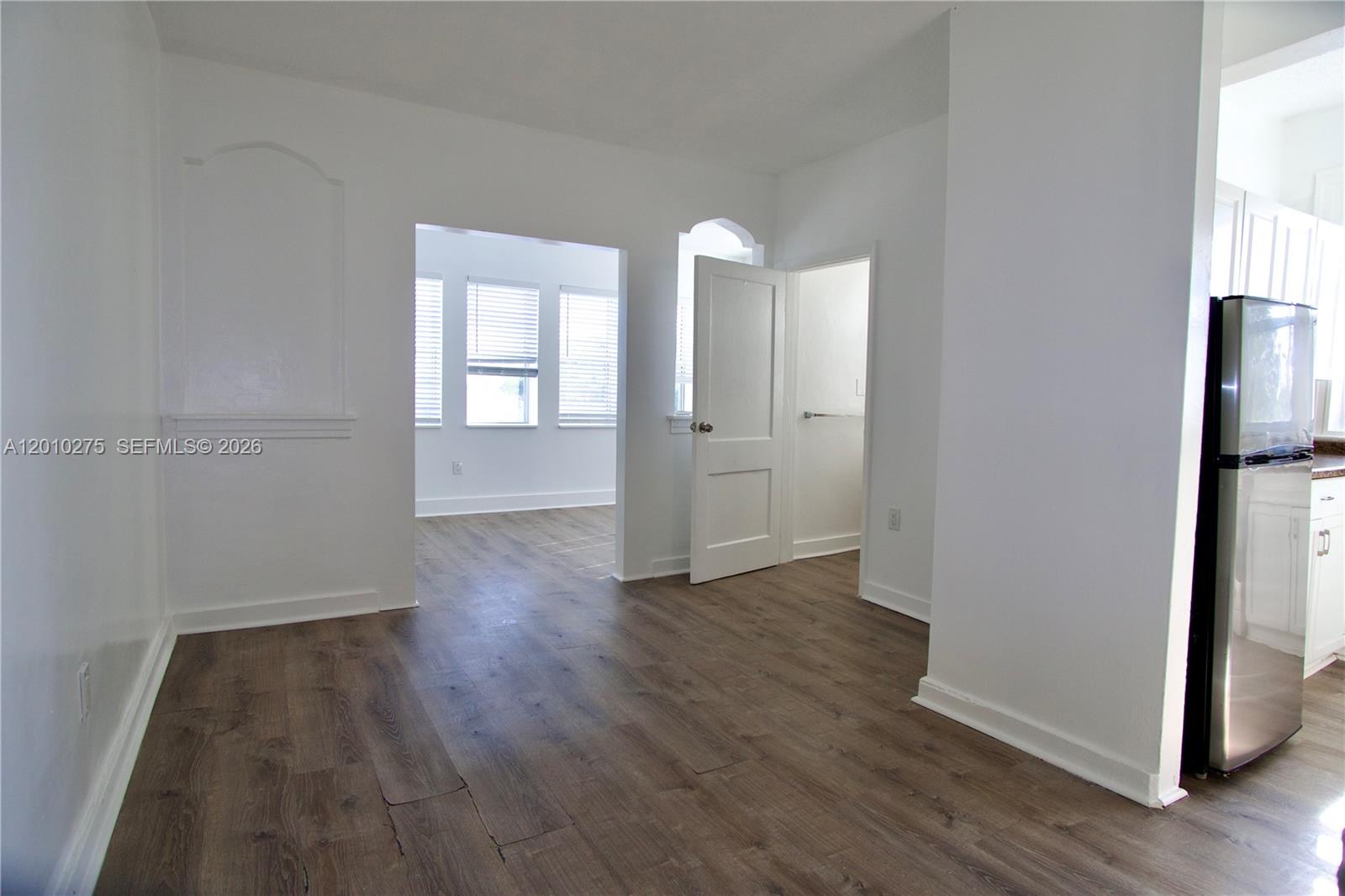 501 Southwest 6th Court, Unit 319 Miami, FL 33130 - Photo 12 of 15 wooden floor in an empty room with a window