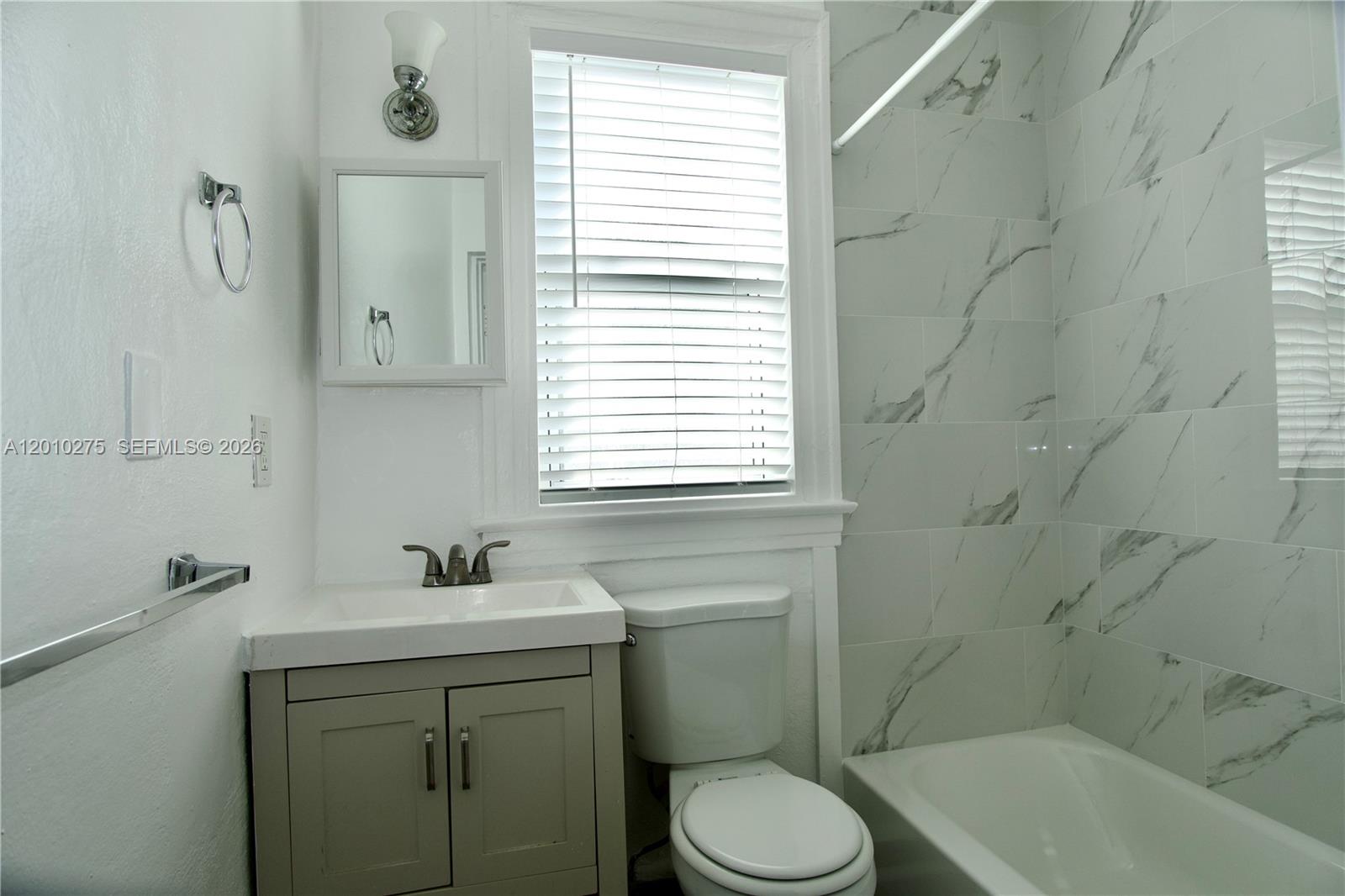 501 Southwest 6th Court, Unit 319 Miami, FL 33130 - Photo 13 of 15 a bathroom with a sink a toilet and shower
