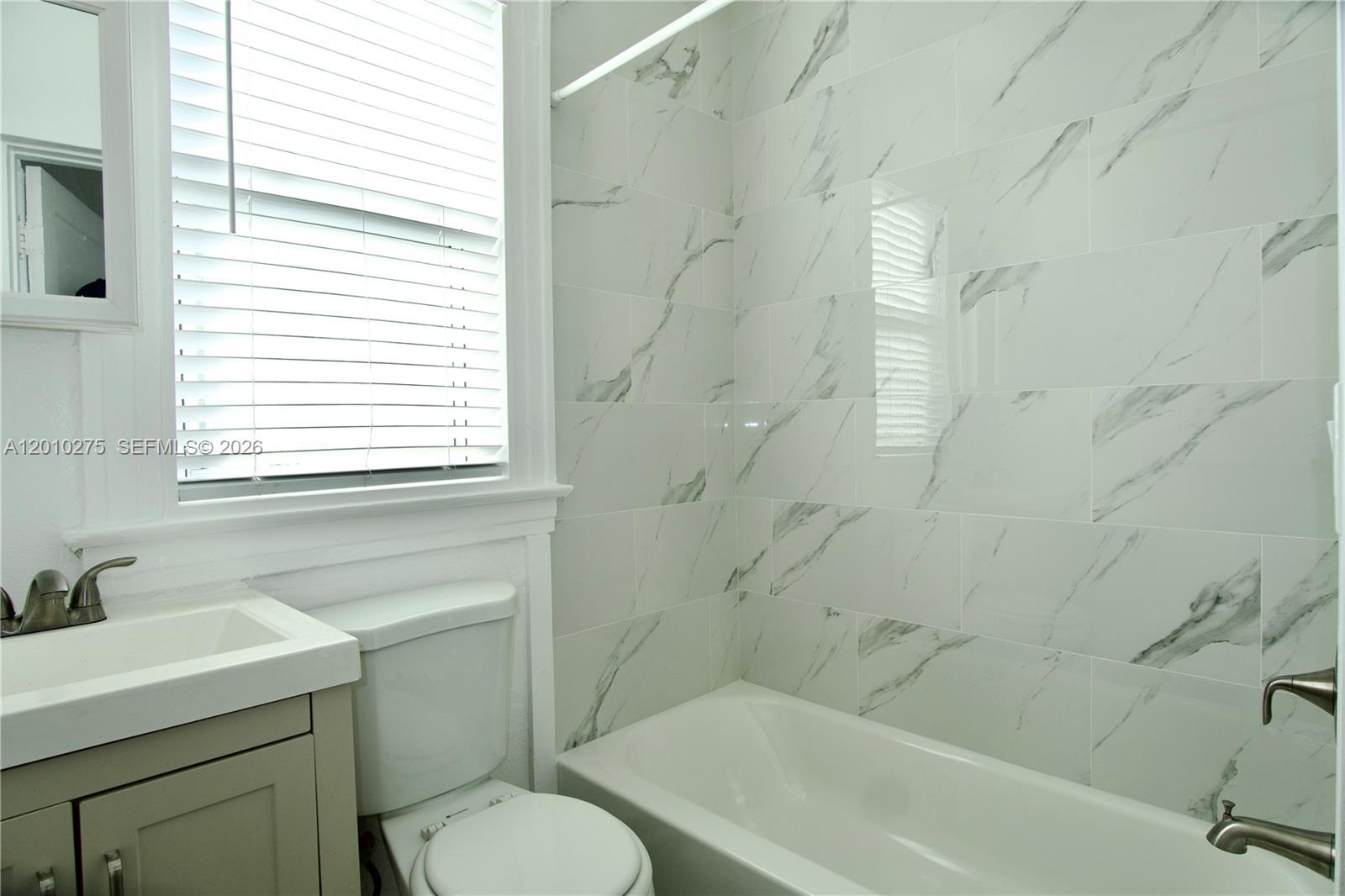 501 Southwest 6th Court, Unit 319 Miami, FL 33130 - Photo 8 of 15 a bathroom with a sink toilet a mirror and shower