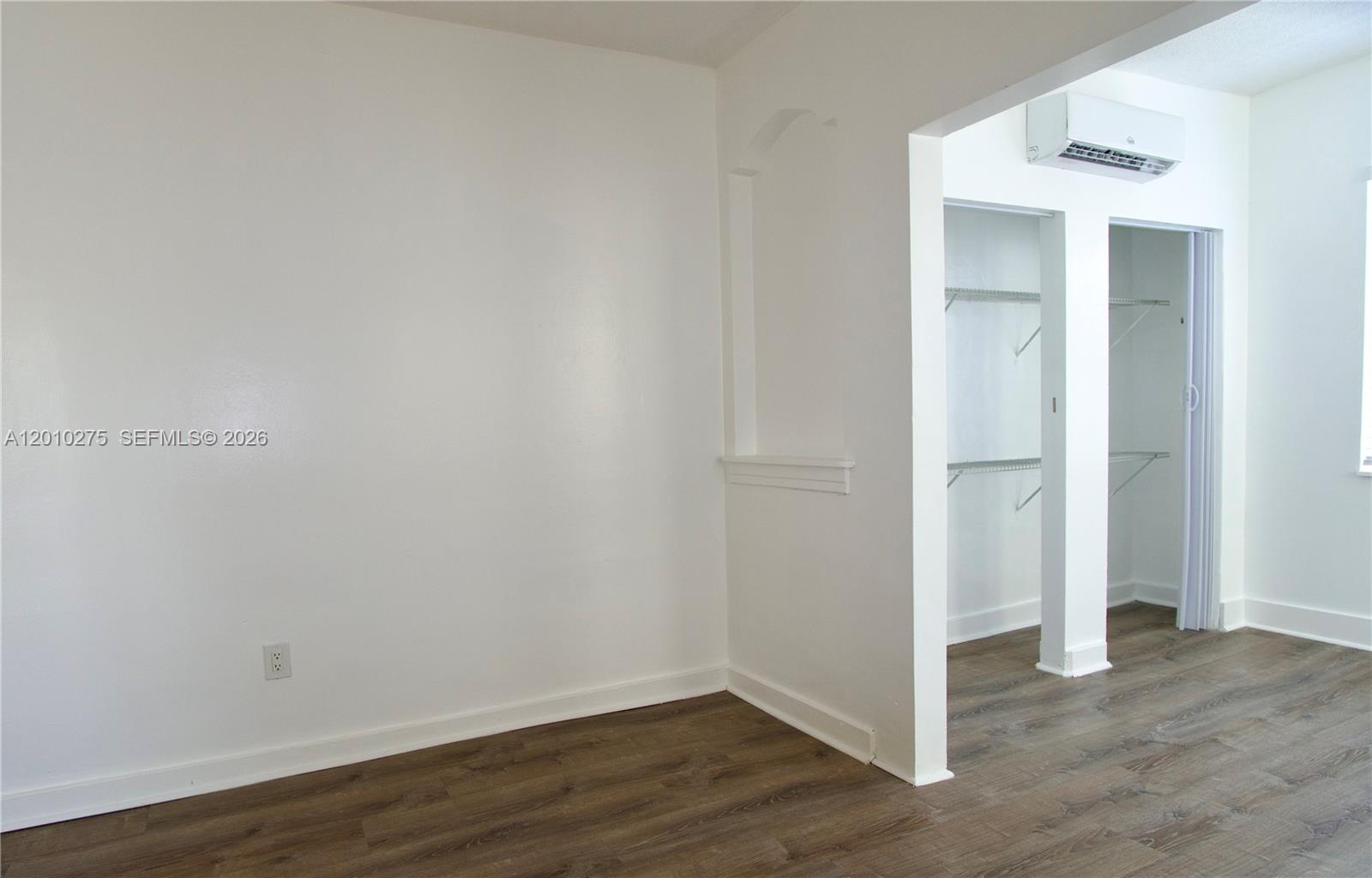 501 Southwest 6th Court, Unit 319 Miami, FL 33130 - Photo 9 of 15 a view of an empty room with wooden floor